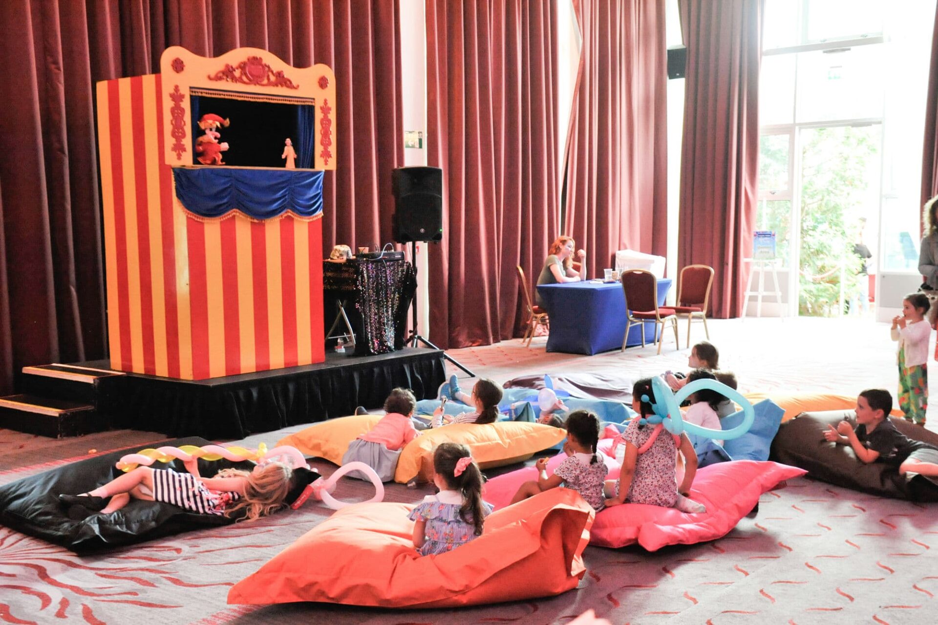 Children are being entertained with a puppet show at a company work party in Dublin
