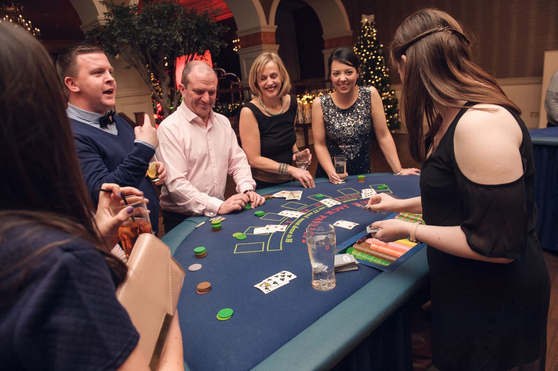 a group of employees are enjoying the blackjack table at a Vegas night themed corporate event in Dublin