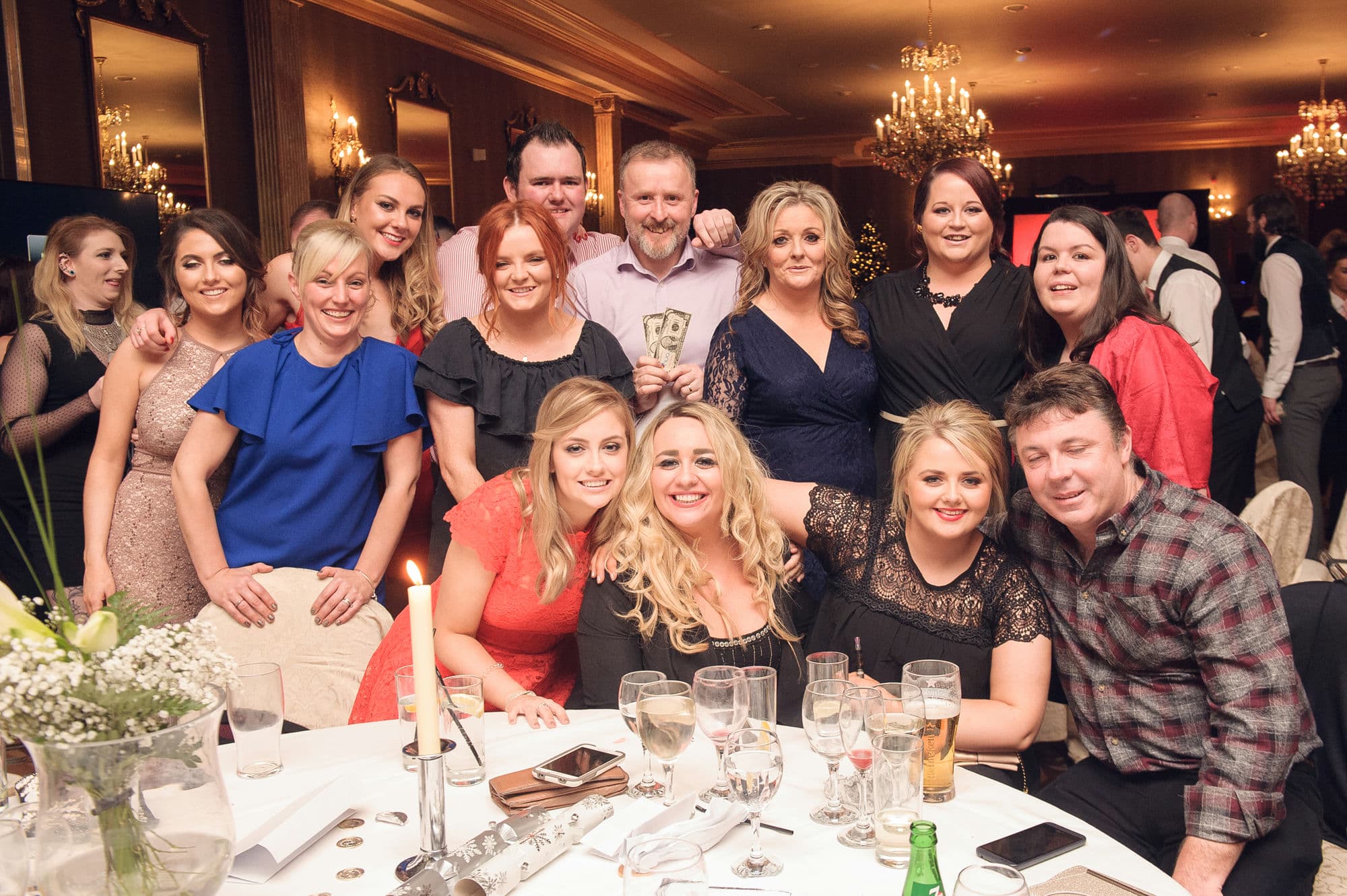 A group of young and happy Irish tech employees are enjoying themselves at a company work party and gala dinner event in Dublin