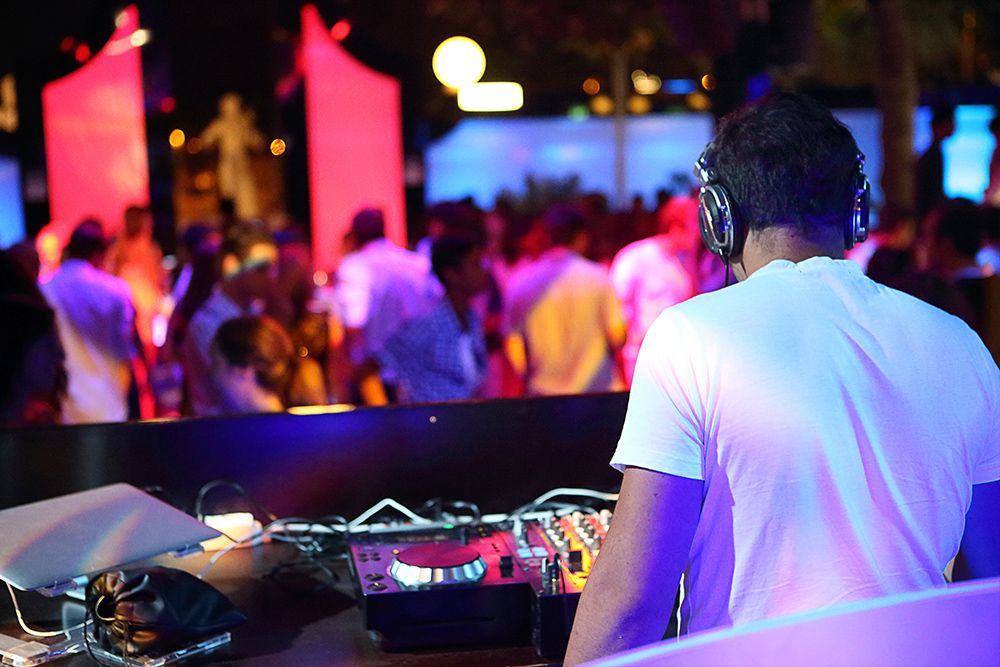 photo of an event DJ playing music for dancers and guests at a corporate function