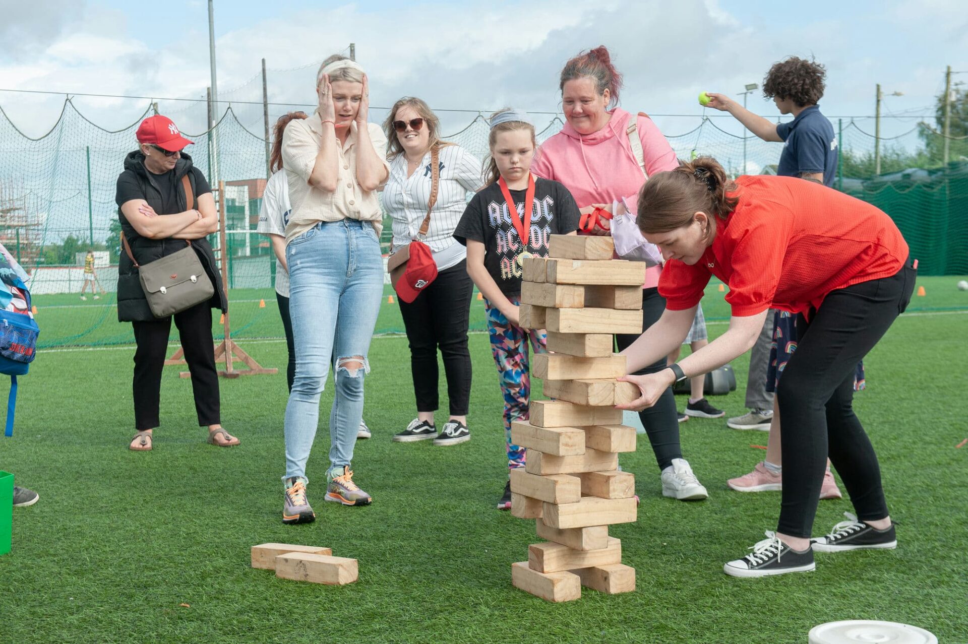 A group of Irish mothers are playing Giant Jenga game as part of a family fun day outdoor event in Cork