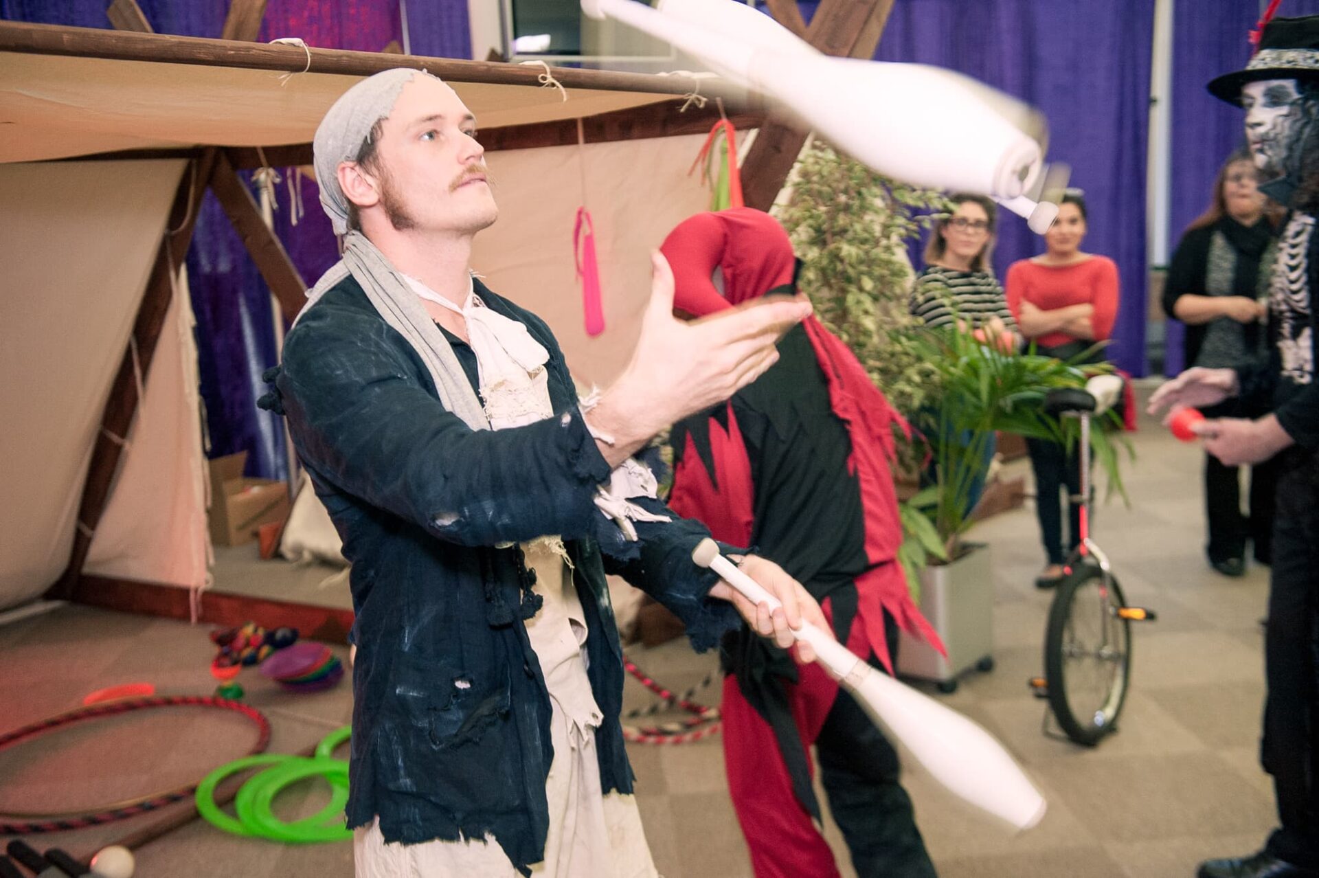a street performer entertains guests at a company event in Dublin by juggling bowling pins
