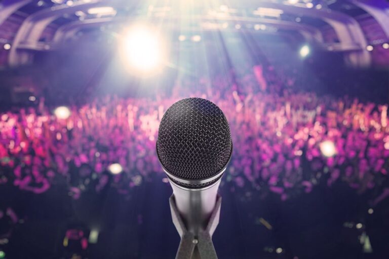 single microphone in front of a large audience at a corporate function