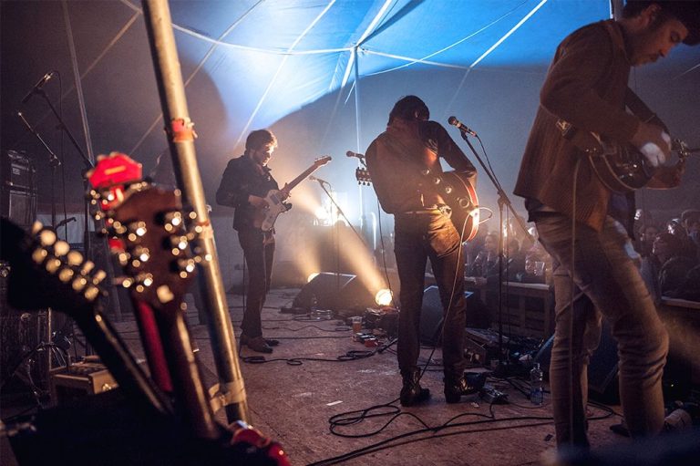 a rock band on stage at a music festival in Ireland