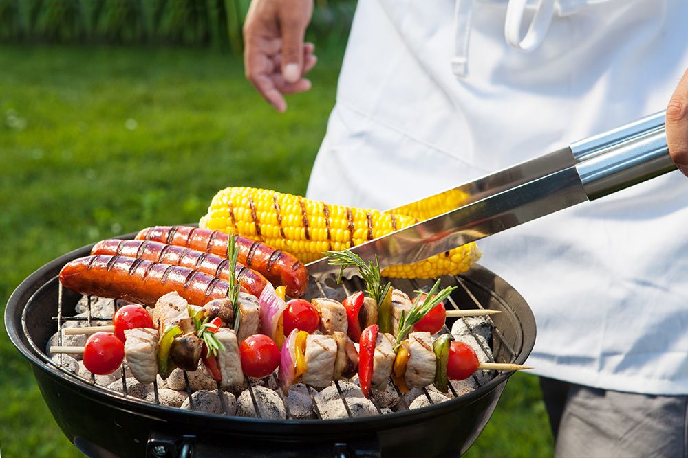 photo of delicious food being cooked on a BBQ at an outdoor event